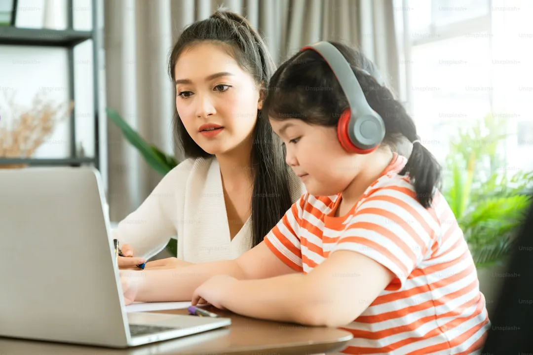 Asian mother helping daughter study online, representing how parents research tuition centres